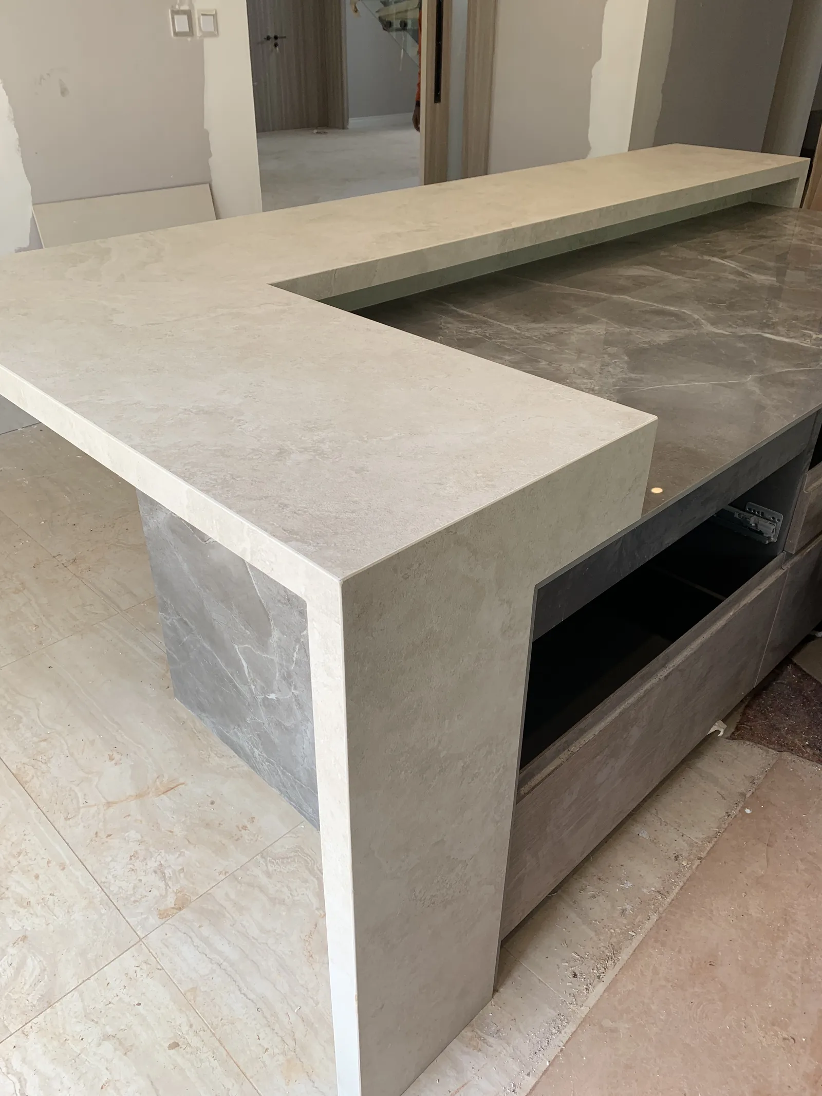 An L shaped bar counter in travertine look stone